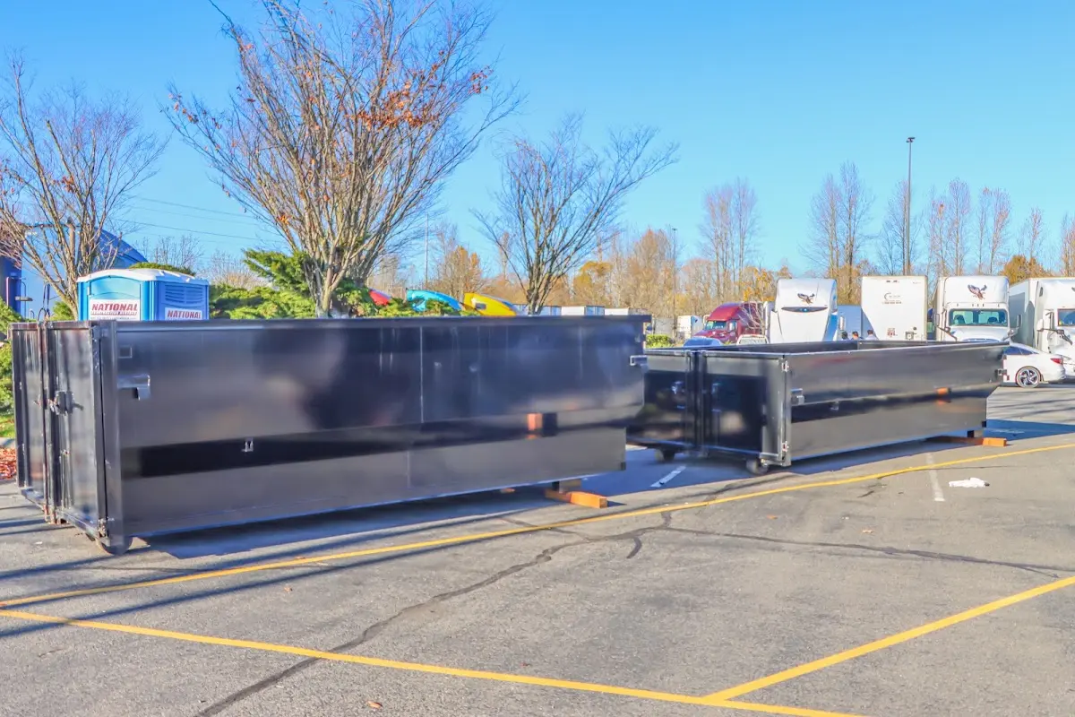 Professional dumpster rental service with roll-off container on residential driveway in Fruitvale